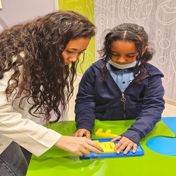 Young learner participating in a UNHCR arts based education session supporting creativity and child development