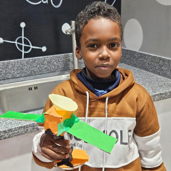 Refugee student engaging in a UNHCR supported education program fostering confidence and youth development